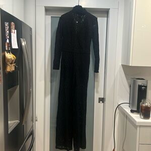 Bebe lace v neck jumpsuit black size 6 shoulder pads